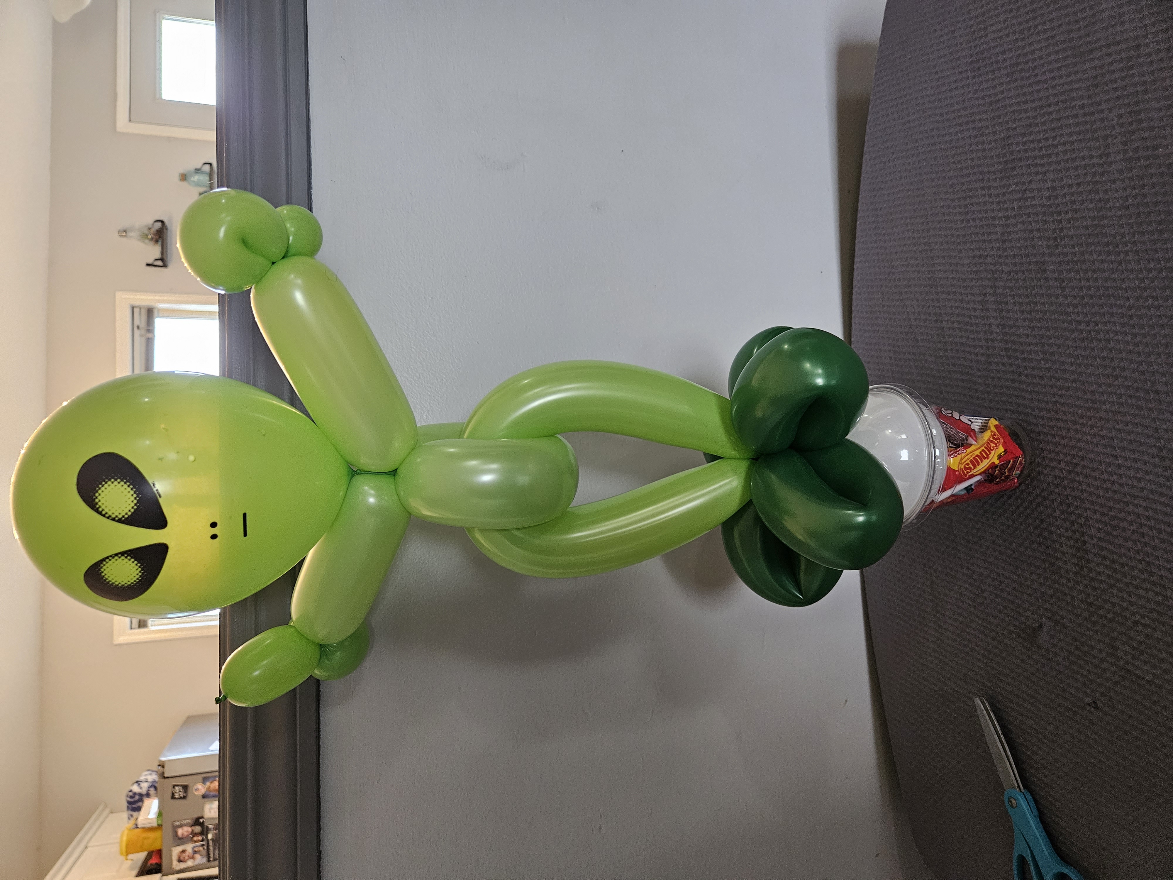 Green Balloon alien on a candy cup