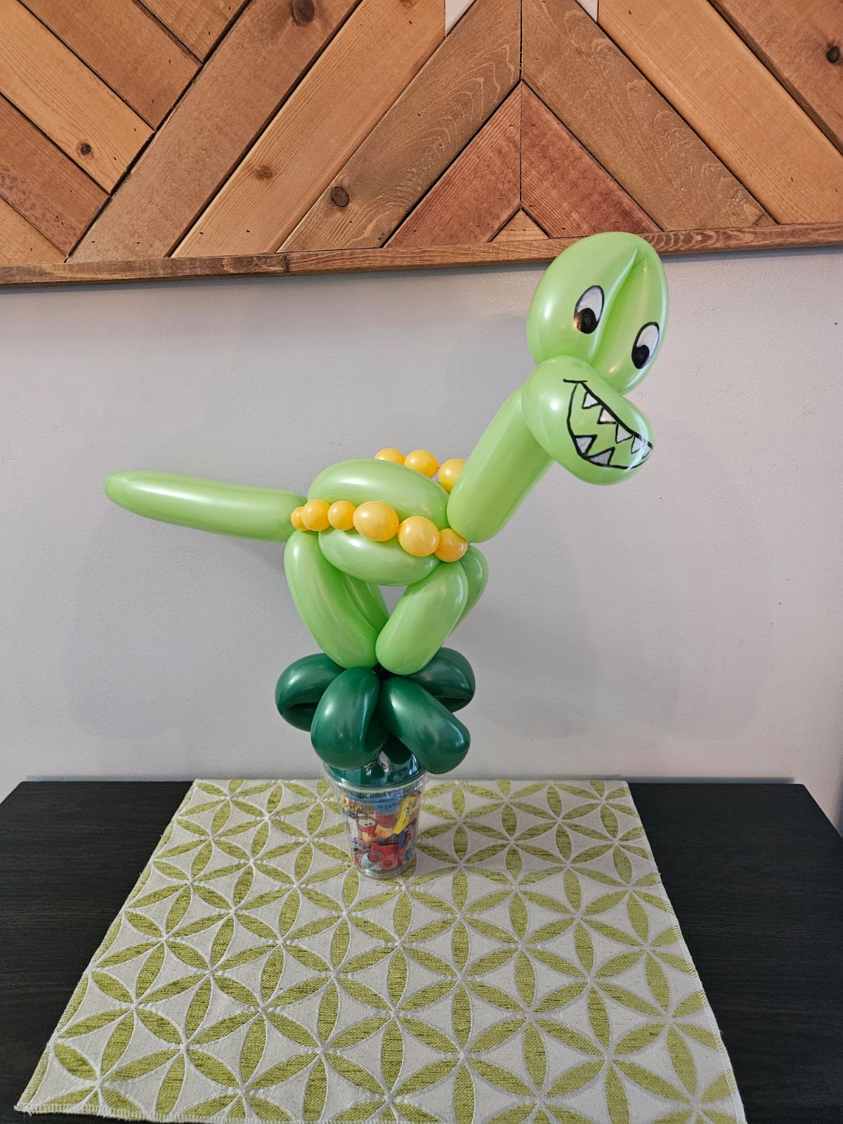 Green and Yellow balloon dinosaur a candy cup